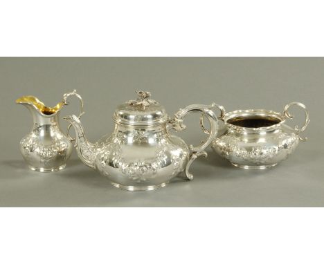A three piece tea service, Elkington & Co, Birmingham 1859, the teapot with floral finial, engraved and embossed swag decorat