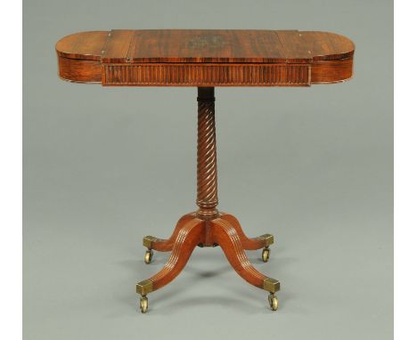 A Victorian rosewood veneered games table, backgammon, chess and cribbage, with turned column and four downswept legs termina