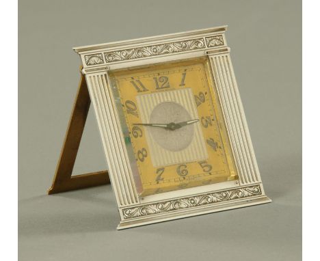 An Art Deco period silver mounted boudoir clock, early 20th century, the square dial with Arabic numerals, with ribbon and fo