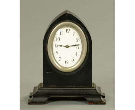 A late Victorian oak cased four glass mantle clock, height 33.5 cm, and an ebony cased lancet topped desk clock, height 15 cm