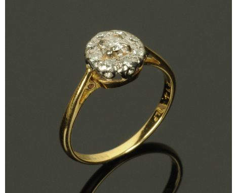 An 18 ct gold diamond cluster ring, size K.