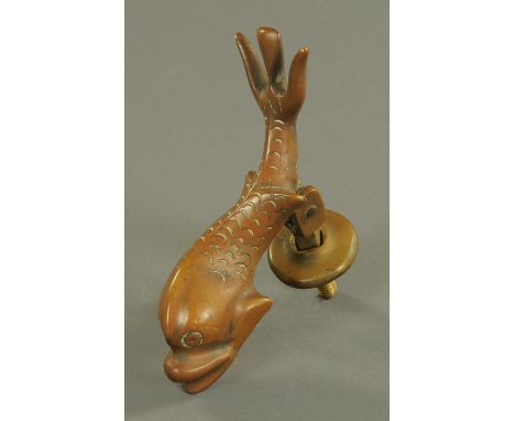 A cast bronze door knocker, 19th century, cast as a dolphin.  20 cm.