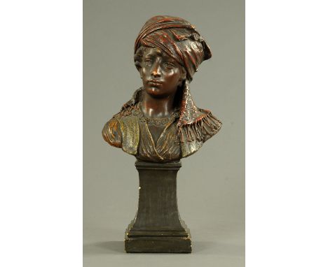 A Goldscheider polychrome bust of a Moorish lady, late 19th century, the bust upon a raised and waisted plinth, and incised "