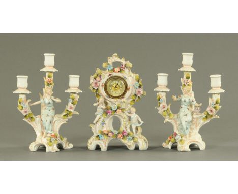 A Continental clock garniture, circa 1900, the clock decorated with two cherubs and floral encrustations on a Rococo base, th