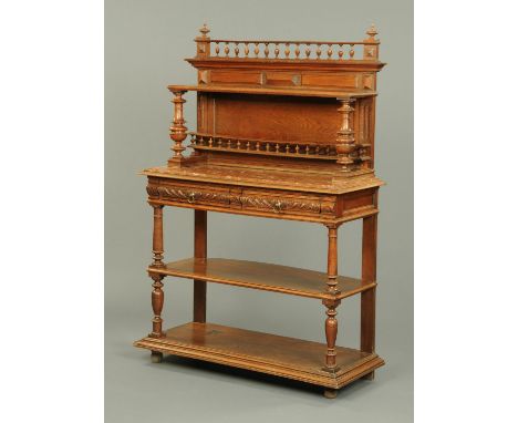 A Victorian oak tiered dumbwaiter, with spindled gallery above a shelf, with further gallery and marble top, the base fitted 