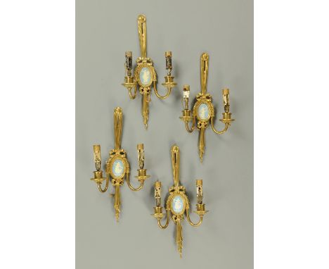 A set of four brass twin branch light fittings, each with oval Jasperware plaque.  Height 48 cm.    CONDITION REPORT:  The me