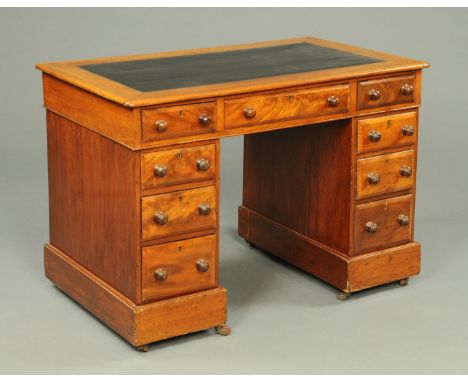 A Victorian mahogany pedestal desk, with black tooled leather writing surface, three frieze drawers and three further drawers