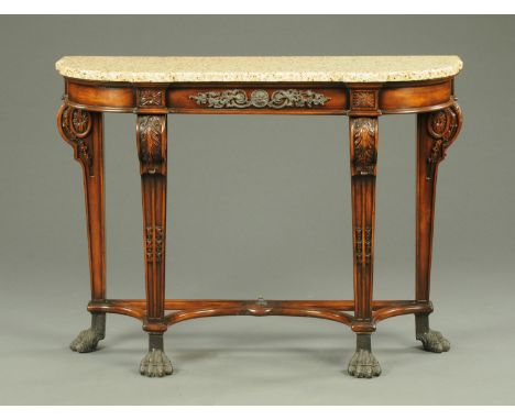 A reproduction mahogany console table, with marble top and raised on carved and moulded legs terminating in metal paw feet.  