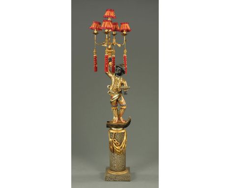 A Blackamoor figure, 20th century, holding aloft a gilt metal five branch light fitting, a tray in his left hand, standing on