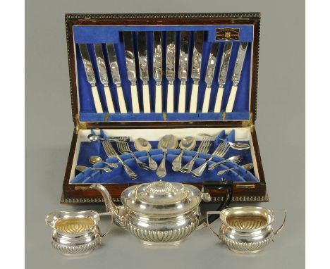 An oak canteen of cutlery, the knives by Viners, and a silver plated tea tea service.