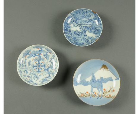 Three Japanese Nabeshima dishes, 19th century, one with two hares jumping across spuming waves (possibly in relation to the w