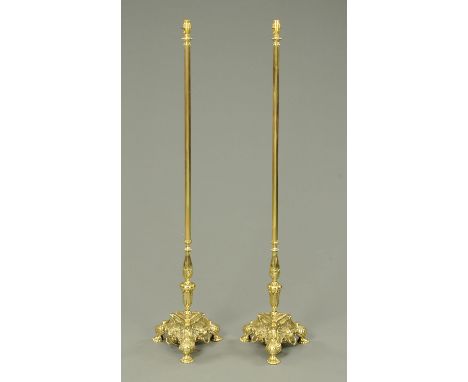 A pair of cast brass standard lamps, 20th century, with fluted stems on cast triform bases and decorated with acanthus leaves