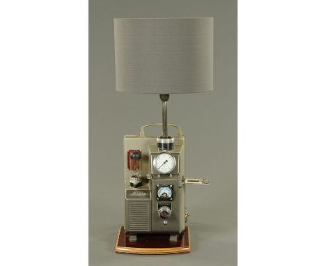 A Steam Punk inspired table lamp, formed from an Aldis projector, with external valves and gauges.  Height including shade 66