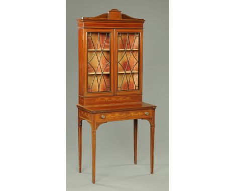 An Edwardian inlaid mahogany ladies desk with bookcase above, with hinged front opening to a green tooled leather writing sur