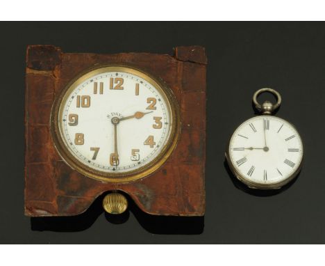 A large eight day knob wind travel clock, with crocodile skin surround, and a silver cased key wind pocket watch. 