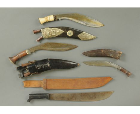 A bone handled Khukri in leather scabbard with silver coloured metal embossed mounts, set with coloured stones, two further K