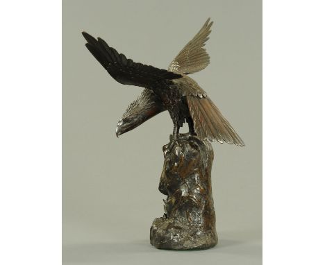 A good Japanese bronze model of a hawk, Meiji period, modelled with its wings outstretched and its neck turned to eye its pre