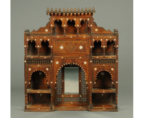 A 19th century Moorish bone inlaid overmantle, fitted with a mirror and series of open shelves, pillars and arches.  Width 12
