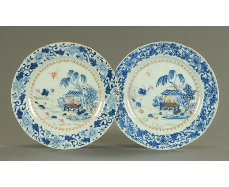 A pair of Chinese Famille Rose plates, mid 18th century, a seated figure and attendant, decorated in polychrome enamels withi