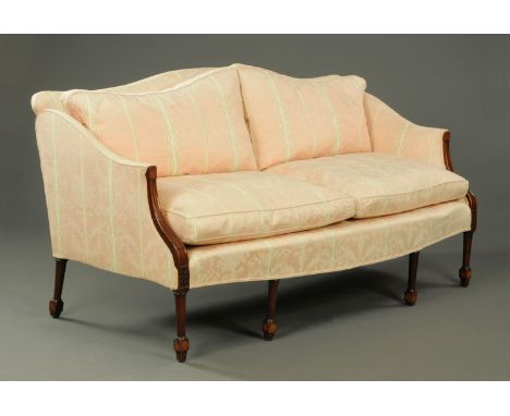 A Georgian mahogany settee, upholstered in pink, foliate, scroll and patterned material, with exposed moulded mahogany arms, 