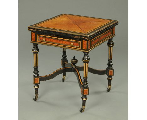 A late 19th century Aesthetic Movement envelope card table in the manner of Gillows of Lancaster, amboyna wood and ebonised a