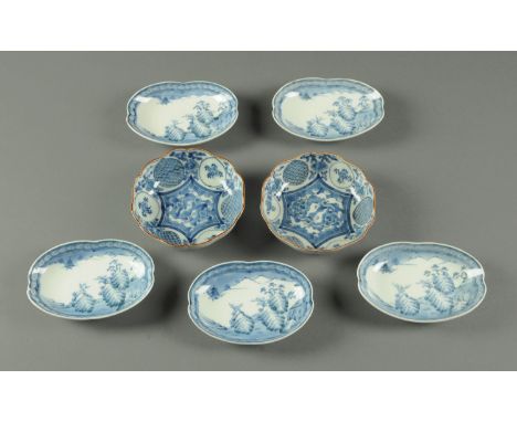 Five Japanese quatreform shaped dishes, early 20th century, with landscape decoration with pine and prunus on rocky outcrops,