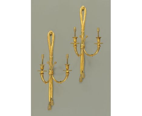 A pair of early 20th century brass twin branch wall light fitments, in the Adam style.  Height 66 cm, width 27 cm. 