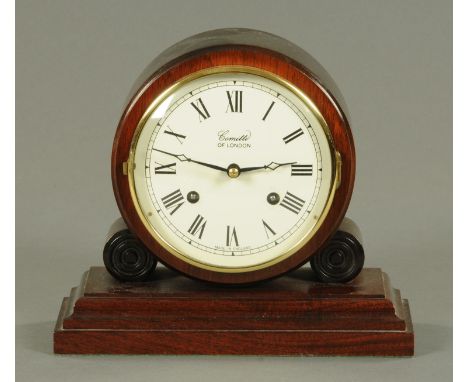 A Committi of London mantle clock, 20th century, of drum form with eight day movement striking on a bell, upon a stepped rect