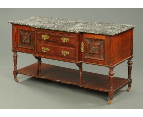 A late Victorian/Edwardian marble topped washstand, fitted with a series of drawers and cupboards raised on turned fluted leg