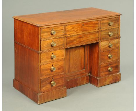 A George III architects desk, panelled all round, with kneehole and secretaire top drawer opening to a writing slope and "alp