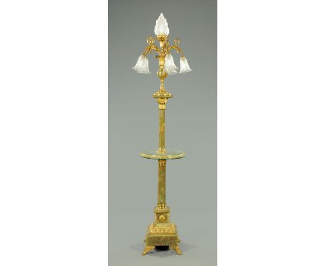 An onyx and gilt brass lamp standard, with flaming torch finial, five further branches with cut glass shades and on cylindric