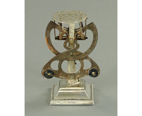 A set of postal scales, raised on a silver base, Sheffield 1903.