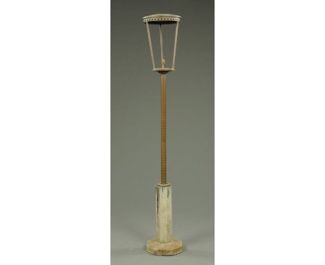 A bronze and concrete exterior lamp post, with bronze cylindrical cover and support leading to an octagonal concrete base.  H