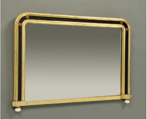 A Victorian overmantle mirror, with gilt moulded and glass frame raised on ceramic feet.  Width 107 cm, height 72 cm. 