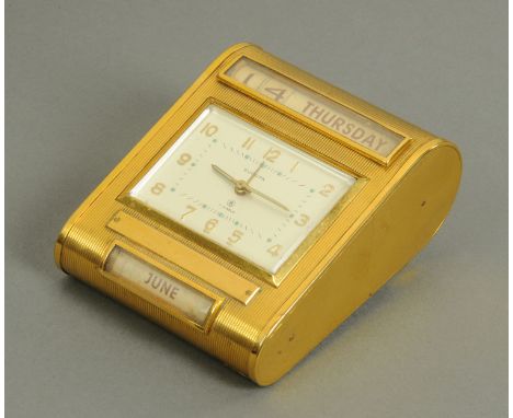 A Europa gilt metal desk calendar clock, circa 1950's/60's, of wedge form with date and day aperture above the rectangular cl