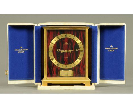 A Jaeger Le Coultre "Embassy Red" Atmos clock, circa 1969, the brass case with red faux marble front and side panels, the bas