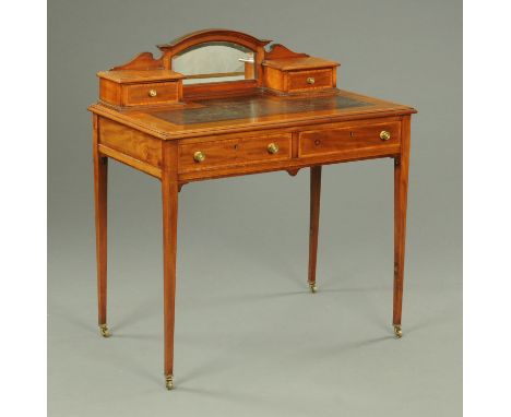 An Edwardian inlaid mahogany desk, with rear upstand, tooled leather writing surface and two frieze drawers and all raised on