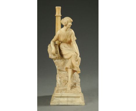 A carved alabaster figural table lamp, modelled as a lady seated on a rocky mound, early 20th century, on a raised weighted b