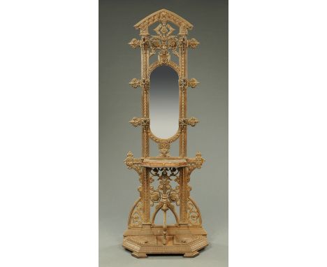A Victorian cast iron hall stand, with mirror, shelf and drip trays.  Width 72 cm.    CONDITION REPORT:  The hall stand appea