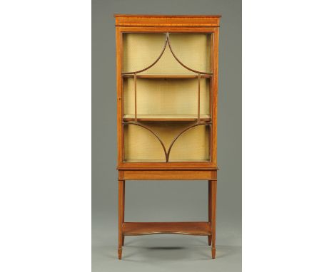 An Edwardian inlaid mahogany display cabinet, with single glazed door with wooden astragals and raised on tapered legs of squ