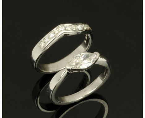 A platinum set pair of rings, single stone marquise diamond +/- 1 carat with WGI Certificate EVS1 and matching half eternity 