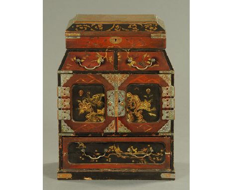 A Kodansu, late 19th century, Japanese lacquer, fitted with a lap type desk.  Width 29.5 cm 