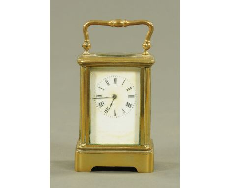 A miniature brass carriage clock timepiece, early 20th century, having an enamel dial with Roman numerals and eight day movem