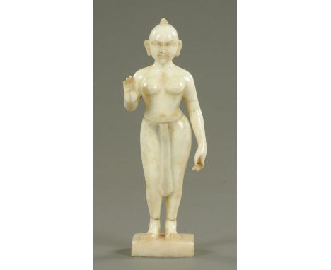 An Indian carved white marble figure, 19th century, standing in Varada Mudra, her hair tied in a top knot and wearing a sash,