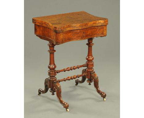 A Victorian walnut backgammon games table, serpentine outline, with frieze drawer, turned legs and stretchers.  Width 55 cm. 