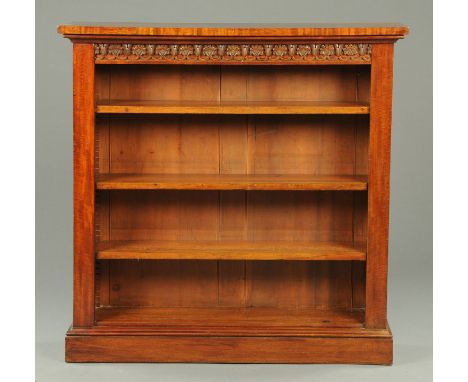 A 19th century mahogany open shelf unit, in the manner of Gillows of Lancaster, with carved frieze, adjustable shelves and pl