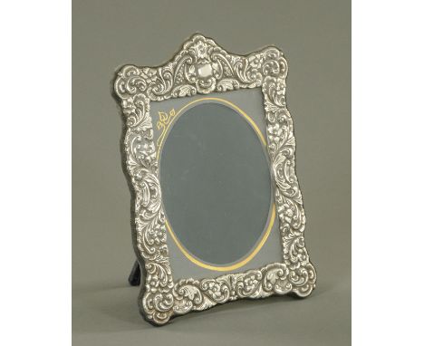 A silver picture frame, Carr's of Sheffield Limited, Sheffield 1991, with embossed scroll shell decoration with vacant cartou