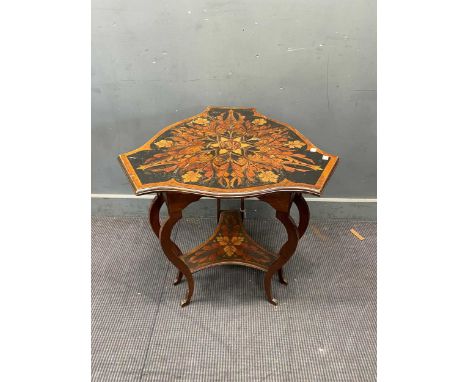 A triform Art Nouveau penwork occasional table, the shaped top decorated with foliate design and central "NM" monogram, raise