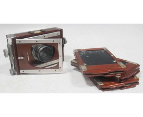 A Shew &amp; Co XIT Patent quarter plate camera, mahogany body, simple lens, with 3 plate holders and leather caseThe ground 