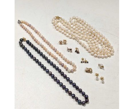 Three freshwater pearl necklaces, each with a clasp stamped '750', together with two pearl clasps stamped '750', a pair of pe